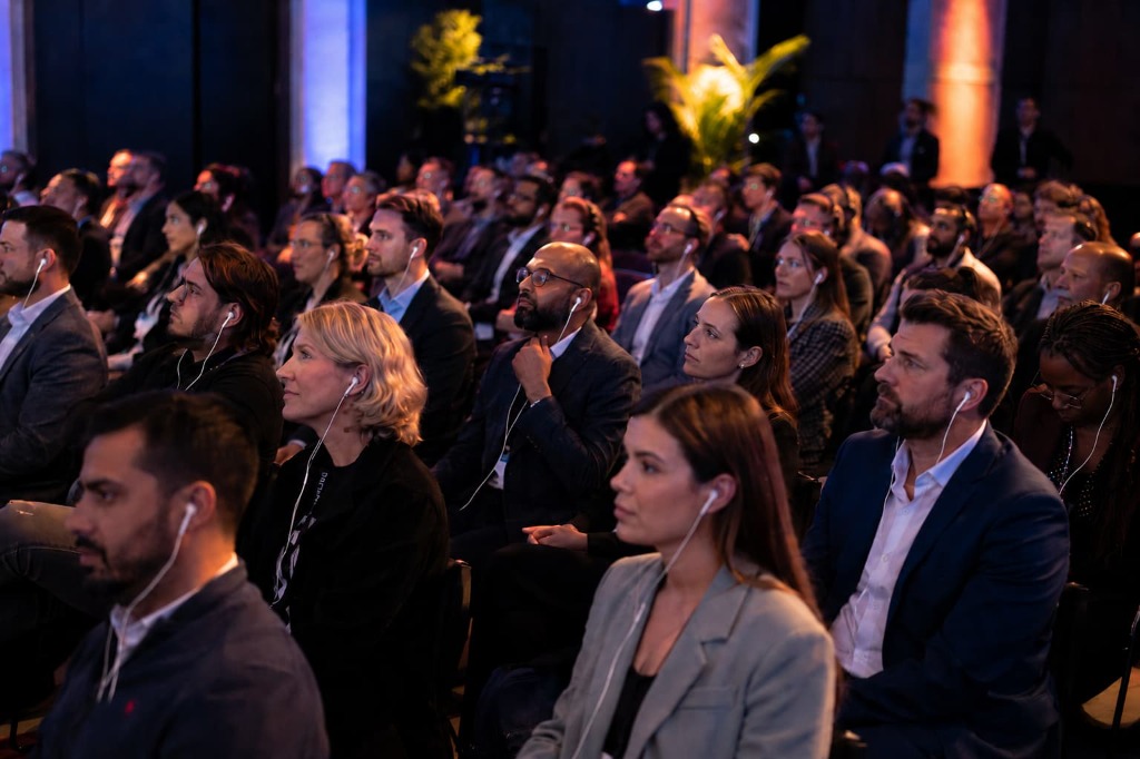 Attendees listening to a silent conference session
